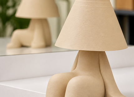 Nordic sitting figure table lamp with textured matte beige finish for modern bedroom and living room decor.